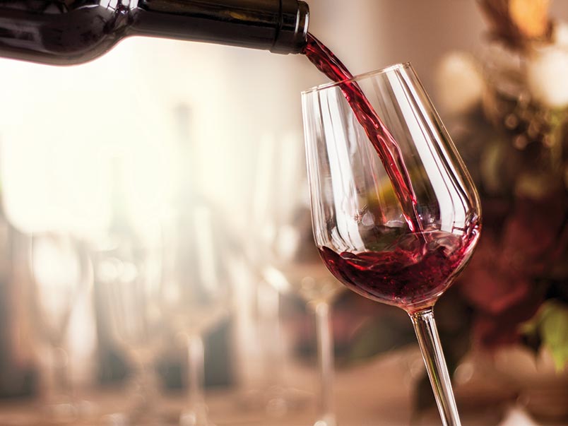 Red wine being poured in to a glass